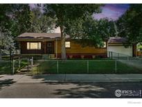 Charming brick home with a fenced yard and mature trees providing ample shade and curb appeal at 610 S Miller Ave, Lafayette, CO 80026