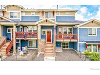 Attractive townhouse featuring a porch and stairs leading to the front door at 619 Brennan Cir, Erie, CO 80516