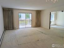 Bright living room with sliding glass doors leading to the balcony at 7040 E Girard Ave # 103, Denver, CO 80224