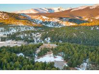 Stunning mountain home surrounded by lush forest and snow-capped peaks at 11780 Gold Hill Rd, Boulder, CO 80302