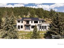 Stunning exterior of modern home featuring solar panels and surrounded by lush greenery at 514 Granite Dr, Boulder, CO 80302