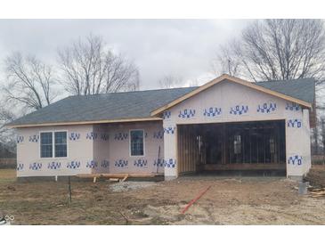 New construction single story home with a dark roof and attached two car garage awaiting finishing at 2071 Friendship Dr, Paragon, IN 46166