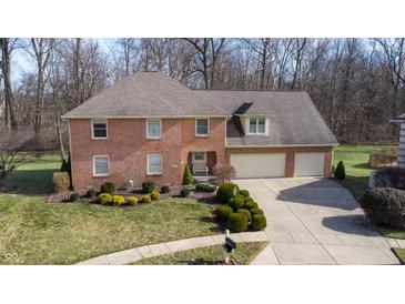Brick two-story house with attached garage and landscaped yard at 4738 Moss Creek Ct, Indianapolis, IN 46237