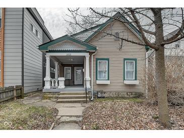 Charming home featuring a covered porch, well-maintained siding, and a welcoming facade at 1433 E Fletcher Ave, Indianapolis, IN 46203