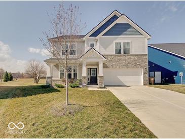 Charming two-story home with stone accents, landscaped yard, and attached two car garage at 2898 Creekridge Ct, Columbus, IN 47201