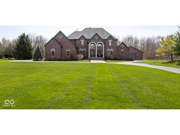 Beautiful brick home with manicured lawn and well maintained landscaping at 4499 W 131St St, Carmel, IN 46074
