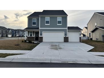 Charming two-story home with a two car garage and manicured landscaping at 696 Scarsdale Ln, Danville, IN 46122