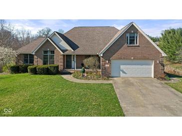 Brick ranch house with attached garage and landscaped lawn at 6093 Boulder Ct, Columbus, IN 47201