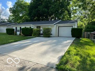 Charming ranch home with a spacious driveway and well-manicured lawn at 2456 Beechcrest Dr, Indianapolis, IN 46203