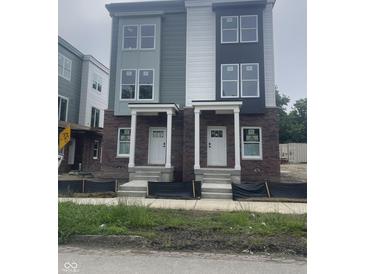 Newly constructed townhomes displaying modern brick and siding, complemented by white trim and inviting front porches at 249 N Temple Ave, Indianapolis, IN 46201