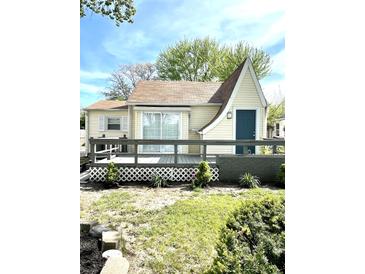 Cute yellow house with deck and landscaped yard at 2709 E Troy Ave, Indianapolis, IN 46203