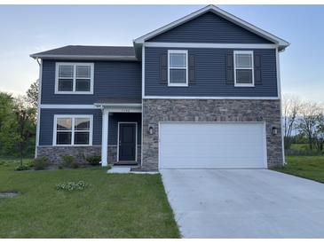 Two story home with blue siding and stone veneer and a two car garage at 7108 Parkstay Ct, Indianapolis, IN 46113