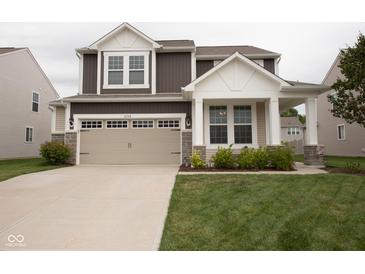 Charming two-story home featuring a two-car garage and a welcoming front porch at 6748 Fallen Leaf Dr, Whitestown, IN 46075