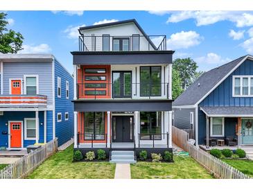 Modern three-story home with eye-catching design and balconies on the second and third floor at 1218 Orange St, Indianapolis, IN 46203