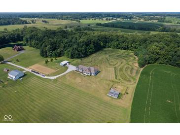 Expansive aerial view of a home with a large yard and wooded area at 9083 W Koger Ln, Martinsville, IN 46151