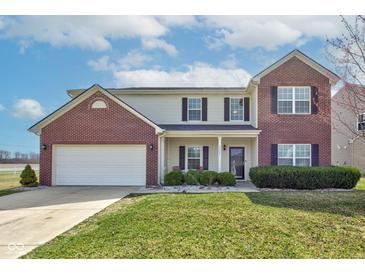 Charming two-story home with brick accents, a well-maintained lawn, and an attached two-car garage at 11851 Fawn Crest Dr, Indianapolis, IN 46235