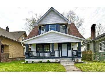 Charming two-story home with a front porch, white siding, and a well-manicured front lawn at 3634 N Kenwood Ave, Indianapolis, IN 46208