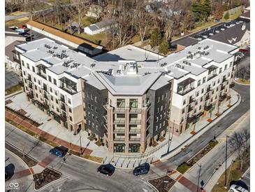 An aerial view of a modern apartment building featuring a unique architectural design at 1155 S Rangeline Rd # 506, Carmel, IN 46032