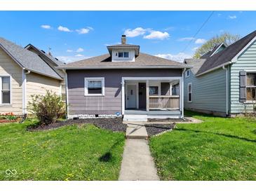 Charming bungalow-style home with a welcoming front porch and well-maintained lawn at 2137 Ringgold Ave, Indianapolis, IN 46203