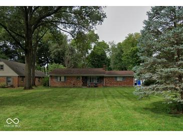 Charming ranch-style home featuring a brick facade and a well-maintained lawn, framed by mature trees at 9634 Maple Dr, Carmel, IN 46280