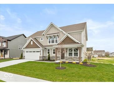 Charming two-story home with manicured lawn and attached two car garage at 1099 Gatewick Ct, Greenwood, IN 46143