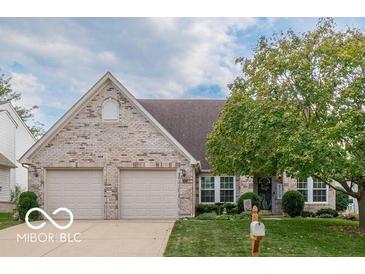 Charming brick home with a manicured lawn, mature tree, and welcoming curb appeal at 7119 Topp Creek Ct, Indianapolis, IN 46214