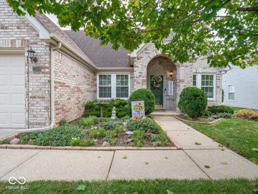 Brick home with manicured lawn, garden and walkway at 7119 Topp Creek Ct, Indianapolis, IN 46214