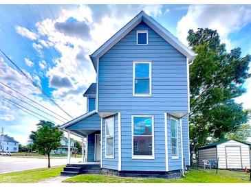 Two-story house with blue siding, front porch, and landscaping at 1011 S Elm St, Muncie, IN 47302