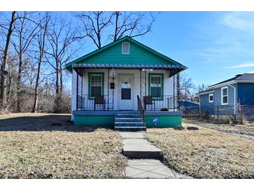 Charming exterior of a quaint, one-story home with a small porch and green trim at 3111 Station St, Indianapolis, IN 46218