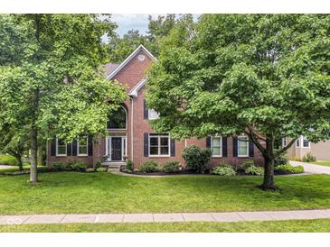 Charming brick two-story home with landscaped front yard and mature trees at 14626 Warner Trl, Westfield, IN 46074