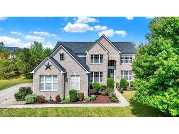 Brick two-story house with landscaped yard and large driveway at 11419 Romeo Pl, Fishers, IN 46040