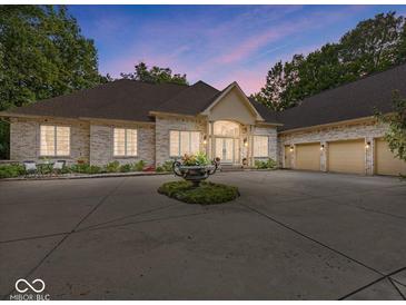 Stunning brick home featuring a circular driveway and three-car garage at 9943 Irishman'S Run Ln, Zionsville, IN 46077
