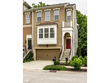 Charming two-story home with a brick and siding exterior, front-entry garage, and a red front door at 729 Greenford N Trl, Carmel, IN 46032