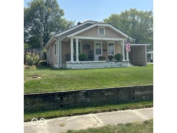 Charming single story home with a covered front porch and an American flag at 217 Ringwood Way, Anderson, IN 46013
