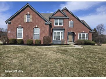 Charming two-story brick home with manicured landscaping and a classic architectural design at 10870 Picket Fence Pl, Fishers, IN 46037