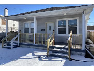 Charming home featuring new wooden porch, neutral siding, and freshly painted stairs, perfect for a cozy retreat at 2729 Massachusetts Ave, Indianapolis, IN 46218