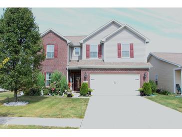 Charming two-story home with a well-manicured lawn and a two car garage at 882 Brookshire Dr, Franklin, IN 46131