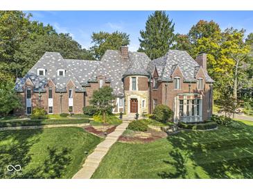 Brick home with slate roof, landscaping, and walkway at 6996 N Washington Blvd, Indianapolis, IN 46220