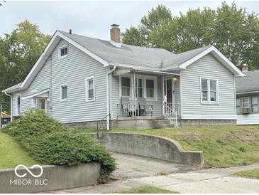 Charming single-Gathering home with light gray siding, a quaint porch and a chimney at , Anderson, IN 46013