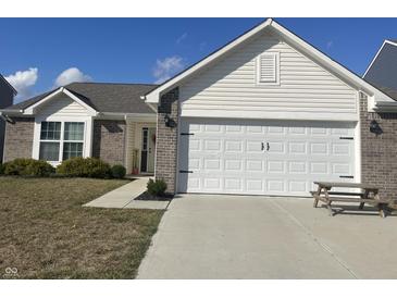 Charming single-Gathering home featuring a two-car garage and neatly landscaped front yard at 2018 Abbey Ln, Columbus, IN 47201