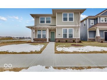 Two-story house with light beige siding, green door and landscaping at 9275 Loyola Way, Plainfield, IN 46168