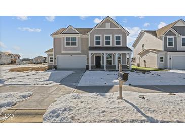 Charming two-story home with a covered porch and attached two-car garage at 10133 Redwood Peak Ln, Indianapolis, IN 46259