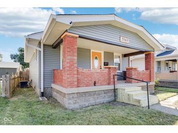 Gray house with brick front porch and steps, nice landscaping at 2161 Napoleon St, Indianapolis, IN 46203