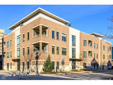 Attractive multi-story brick building featuring large windows and a well-maintained landscaped area at 504 N Park N Ave # 4, Indianapolis, IN 46202