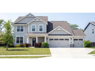 Charming two-story home with a three car garage and a well-maintained lawn at 5573 Mahogany Dr, Noblesville, IN 46062