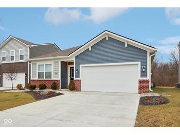 Charming single-story home with blue siding, brick accents, a two-car garage, and a well-manicured front yard at 10008 Sundley Dr, Indianapolis, IN 46239