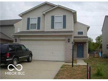 Charming two-story home featuring a two-car garage and a well-maintained lawn at 5325 Bluff View Dr, Indianapolis, IN 46217