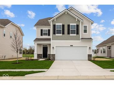 Charming two-story home featuring a gray and white color scheme, a two-car garage, and a well-manicured lawn at 1833 James Pierce Dr, Shelbyville, IN 46176