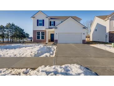 Two-story house with white siding, brick accents, and a two-car garage at 1042 Stubble Run, Danville, IN 46122