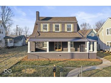 Charming two-story home featuring a covered front porch and brick facade at 1429 Brookside Pkwy N Dr, Indianapolis, IN 46201